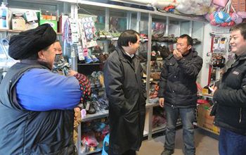 researchers talking to chinese locals in a store in Wolong